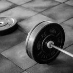 black barbell on tile flooring